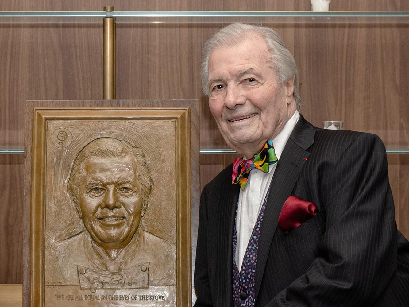 Jacques Pépin standing in front of award