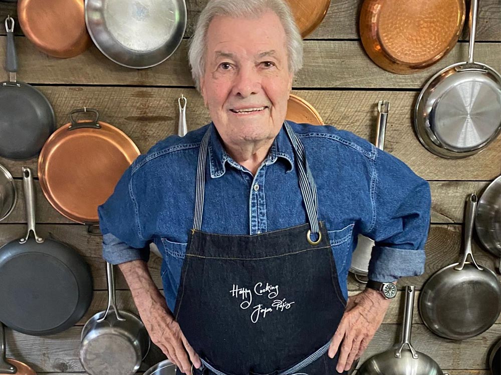 Jacques P&eacute;pin wearing signature apron