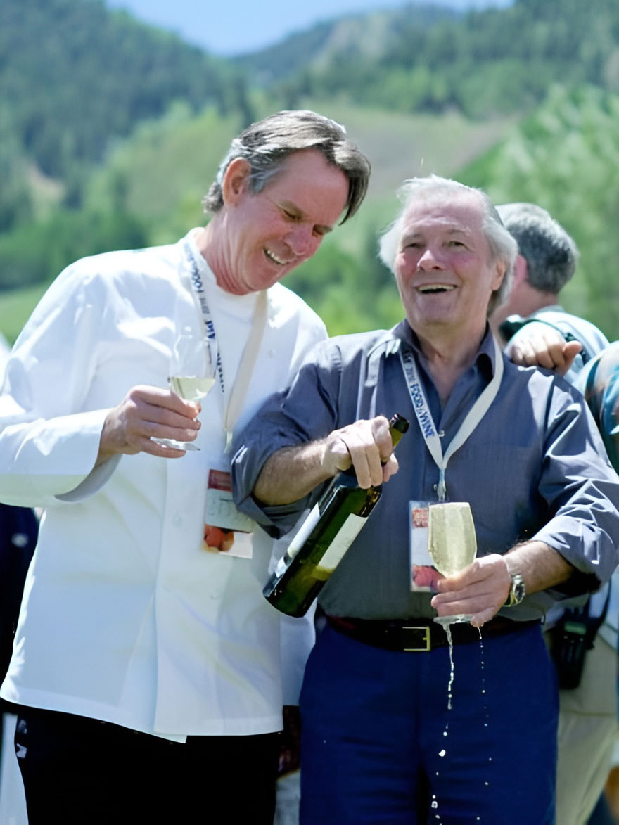 Thomas Keller and Jacques Pepin celebrating with champagne