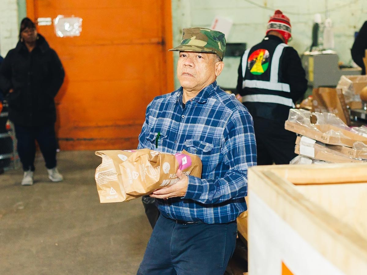Man in warehouse with package of food