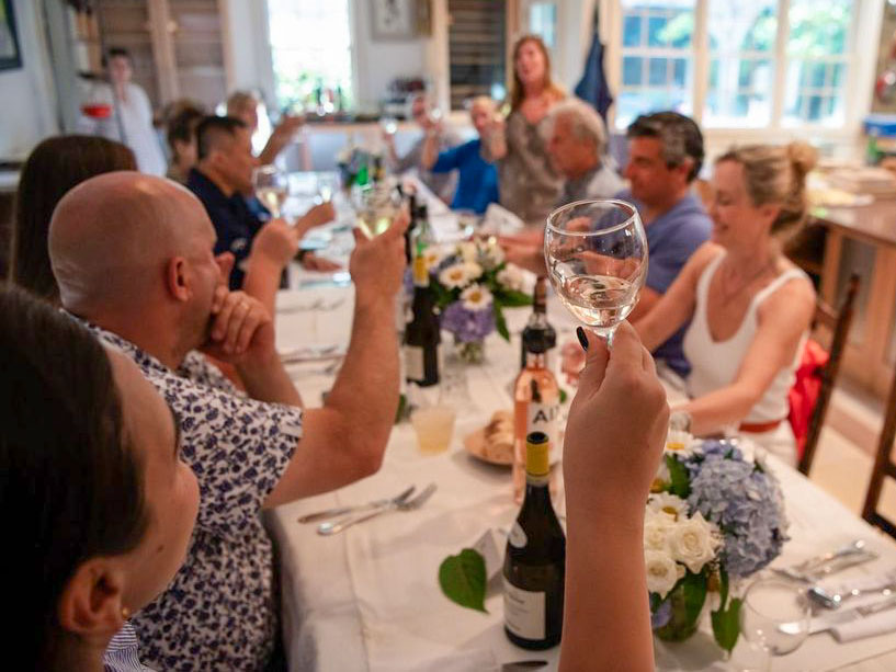 Guests at a dinner table toasting
