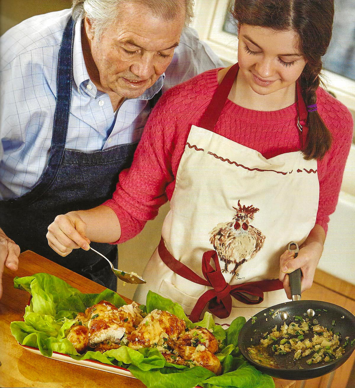 Jacques Pepin working in the kitchen with granddaughter Shorey