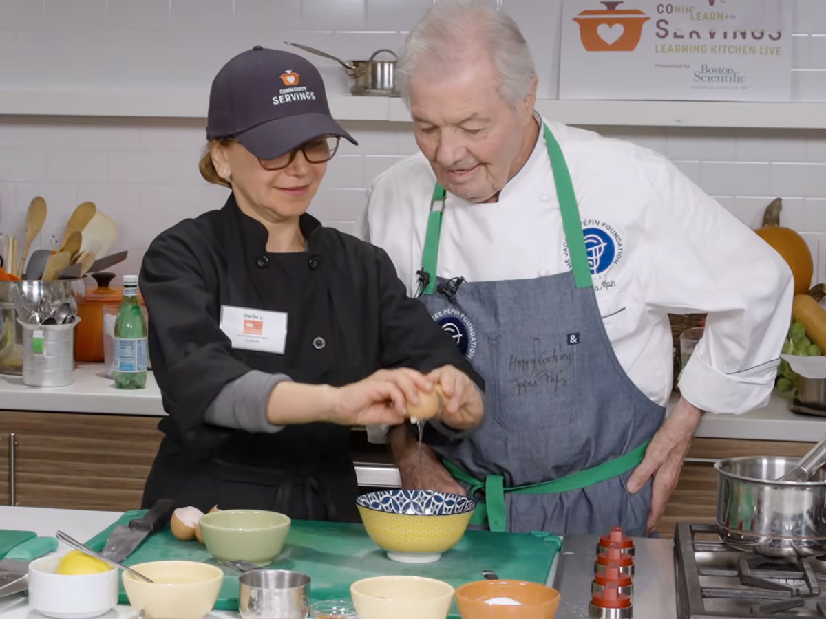 Jacques Pépin working with a culinary student